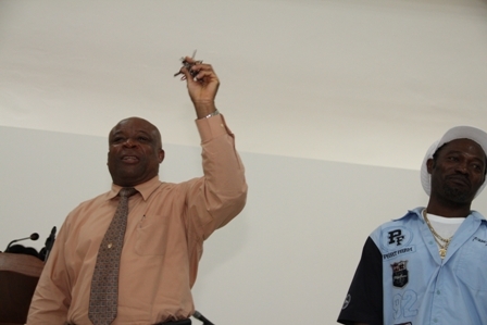 (L-R) Minister for Social Development on Nevis Hon. Hensley Daniel showing keys for the new Combermere Community Centre from Contractor Mr. Livingston Mills